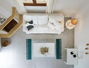 a living room with a white couch on the floor at Sanidiamonds in Sani Beach