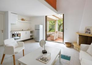 a kitchen and living room with a table and a refrigerator at Sanidiamonds in Sani Beach