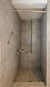 a shower with a shower head in a bathroom at Sanidiamonds in Sani Beach