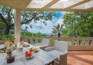 a table with plates of fruit on a patio at Sanidiamonds in Sani Beach