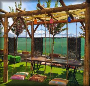 a wooden pergola with a table and chairs at The Kayseri Loft Hotel in Kayseri