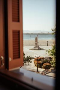 a view of the beach from a window at Espero Royal Stay in Nafplio