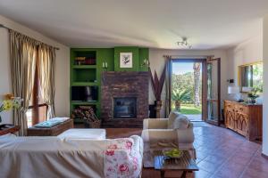 a living room with a couch and a fireplace at Deliziosa Villa a 500 metri dal mare con Piscina in Terrasini