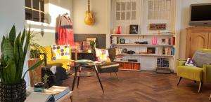 a living room with yellow chairs and a table at Ahoi in Wesselburenerkoog