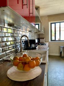 a bowl of oranges on a counter in a kitchen at Maison Face au Soleil in Le Bois-Plage-en-Ré