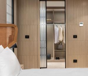 a bedroom with a bed and a closet at Radisson Collection Hotel, Bodrum in Akyarlar