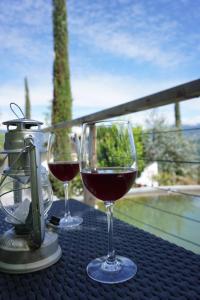 two glasses of red wine sitting on a table at Zum Schwarzen Kus in Caldaro
