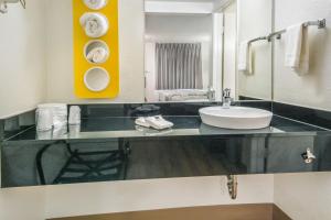 a bathroom with a sink and a mirror at Motel 6-Irving, TX - Dallas in Irving +33 photos