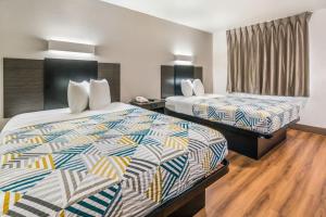 a hotel room with two beds in a room at Motel 6-Irving, TX - Dallas in Irving