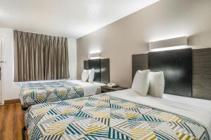 a hotel room with two beds in a room at Motel 6-Irving, TX - Dallas in Irving