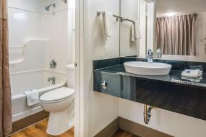 a bathroom with a white toilet and a sink at Motel 6-Irving, TX - Dallas in Irving