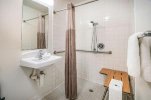a bathroom with a sink and a shower at Motel 6-Irving, TX - Dallas in Irving