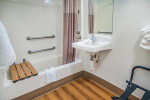 a bathroom with a sink and a mirror and a shower at Motel 6-Irving, TX - Dallas in Irving