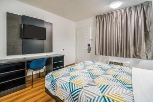 a hotel room with a bed and a desk at Motel 6-Irving, TX - Dallas in Irving