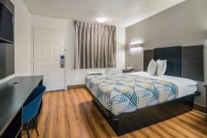 a hotel room with a bed and a desk at Motel 6-Irving, TX - Dallas in Irving