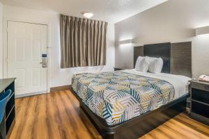 a hotel room with a bed and a window at Motel 6-Irving, TX - Dallas in Irving