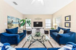 a living room with blue couches and a tv at The Rookery Unit 3501 in Gulf Shores