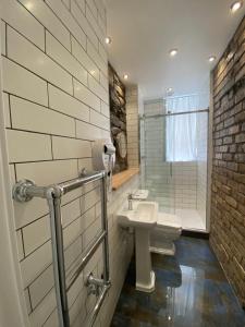 a bathroom with a toilet and a sink and a shower at Royal Mile Romance by Heritage Of Scotland LLP in Edinburgh