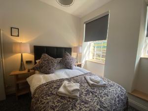 a bedroom with a bed with two towels on it at Royal Mile Romance by Heritage Of Scotland LLP in Edinburgh