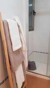 a towel rack with towels on it next to a shower at Ático La Marina in Puerto del Rosario