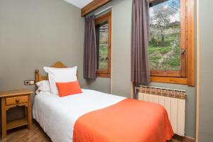 
Кровать или кровати в номере Aparthotel AnyosPark Mountain & Wellness Resort
