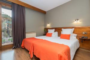 
Кровать или кровати в номере Aparthotel AnyosPark Mountain & Wellness Resort
