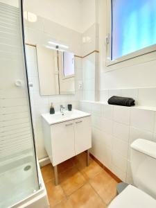 a white bathroom with a sink and a shower at Balcon du Faron- Proche Gare & Centre ville - Clim in Toulon
