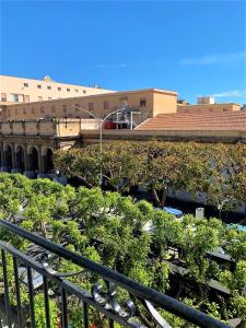 a view of a building with trees and a train at 55 Aira Hotel in Palermo