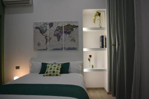 a bedroom with a bed with a map on the wall at La casa di Maria in Naples