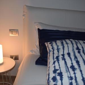 La casa di Maria في نابولي: سرير لحاف ازرق وبيض وطاولة