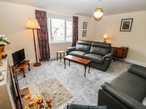 a living room with a couch and a table at Idan House in Llanfairpwllgwyngyll