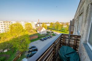 a balcony with cars parked in a parking lot at Holyday apartment in Haapsalu