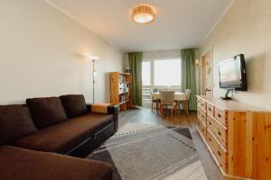 a living room with a couch and a flat screen tv at Holyday apartment in Haapsalu