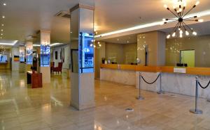 a lobby with a counter in the middle of a building at Cresta Grande Cape Town in Cape Town