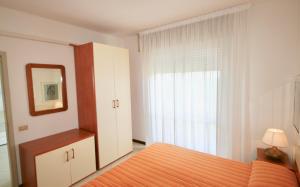 リニャーノ・サッビアドーロにあるBA- LA TORRE - Sea View -のベッドルーム1室(ベッド1台、鏡、窓付)