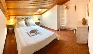 a bedroom with a large white bed in a room at Apartment Praia Arrifana with BALCONY and SEA VIEW in Aljezur