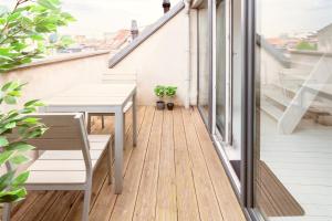 a balcony with a table and chairs on a building at Beautiful Cozy Apartments in the Heart of Antwerp in Antwerp