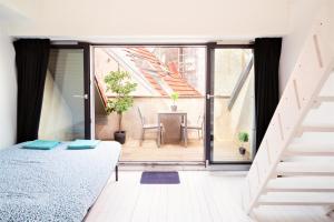 a bedroom with a bed and a balcony at Beautiful Cozy Apartments in the Heart of Antwerp in Antwerp