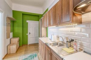 a kitchen with a sink and a green wall at 6 can stay! Parking Free! Old Town 6min. Shop 3min in Riga