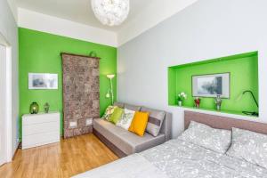 a green room with a bed and a couch at 6 can stay! Parking Free! Old Town 6min. Shop 3min in Riga
