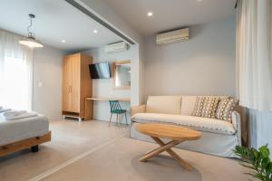 a living room with a couch and a table at ARMONIA 1 & 2 in Myrina