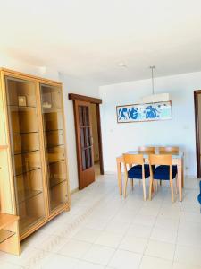 a dining room with a wooden table and chairs at Apartamento Playa Peñíscola in Peniscola