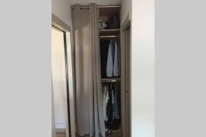 un armario con espejo y un armario con ropa en Meublé T2 Moderne en Hyper centre en Vittel