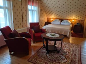 une chambre d'hôtel avec un lit, deux chaises et une table dans l'établissement Avinurme Hostel, à Avinurme