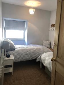 a bedroom with two beds and a window at St Martins Apartment Stamford in Stamford