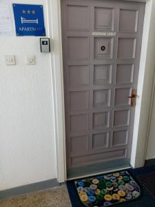 a door with a door mat in front of it at Art Apartman in Plitvička Jezera