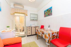 a living room with a table and a kitchen at Dubrovnik center apartment in Dubrovnik