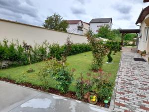 a garden with flowers and plants in a yard at Noblesse House in Deva
