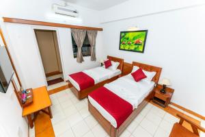 a hotel room with two beds in a room at Hotel Green Field in Satara