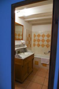 a bathroom with a sink and a tub at La Bergerie de l'etang in Montels